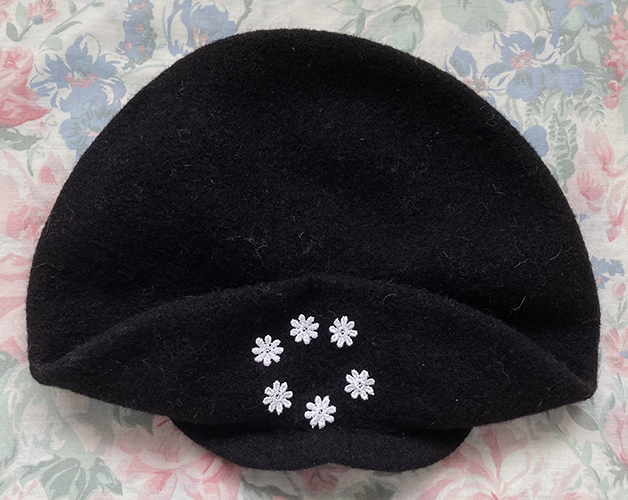 black beret with daisies