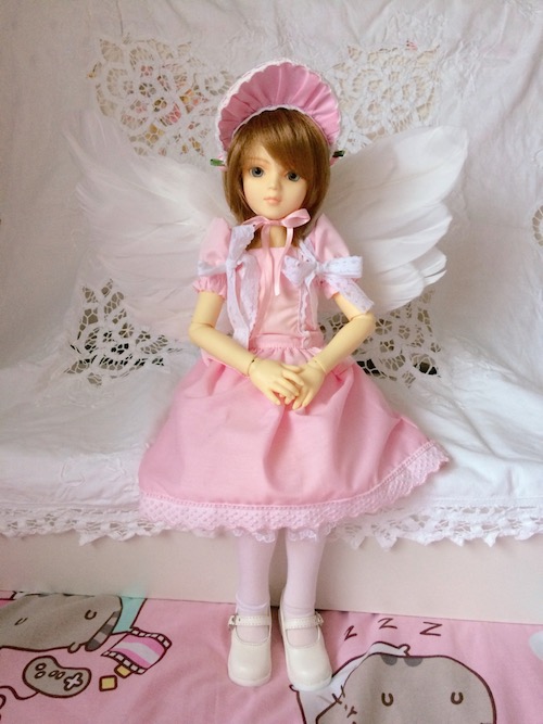 full body of hattie sitting in front of a doily