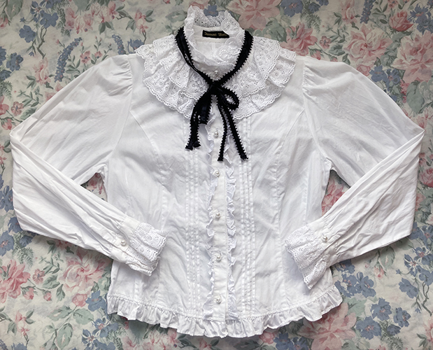 high neck white blouse with black ribbon